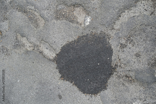 partly repaired pothole in road