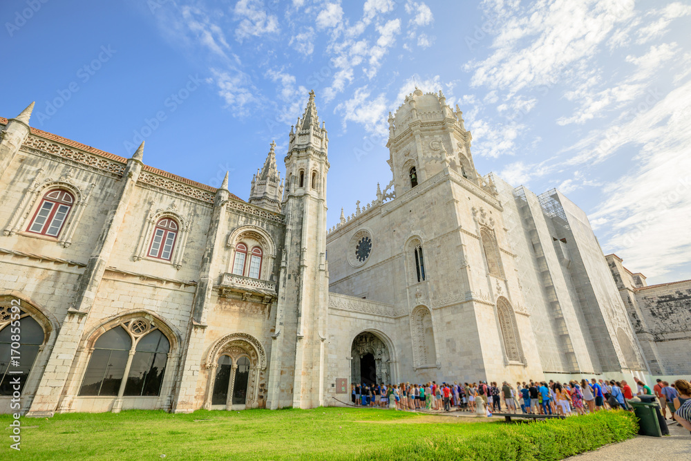 Crowd of people at entrance of Hieronymites Monastery or Mosteiro dos Jeronimos, Lisbon, Belem district on blurred background. The monastery is one of the city's main attractions and popular landmark