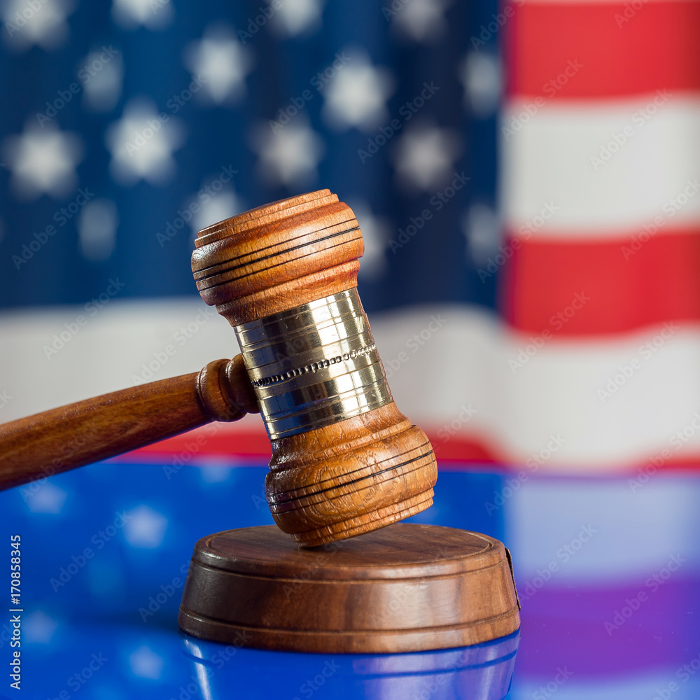 Law and justice symbols on American flag background.