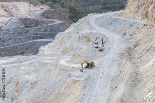 The tracked excavators are operating in the stone quarry.
