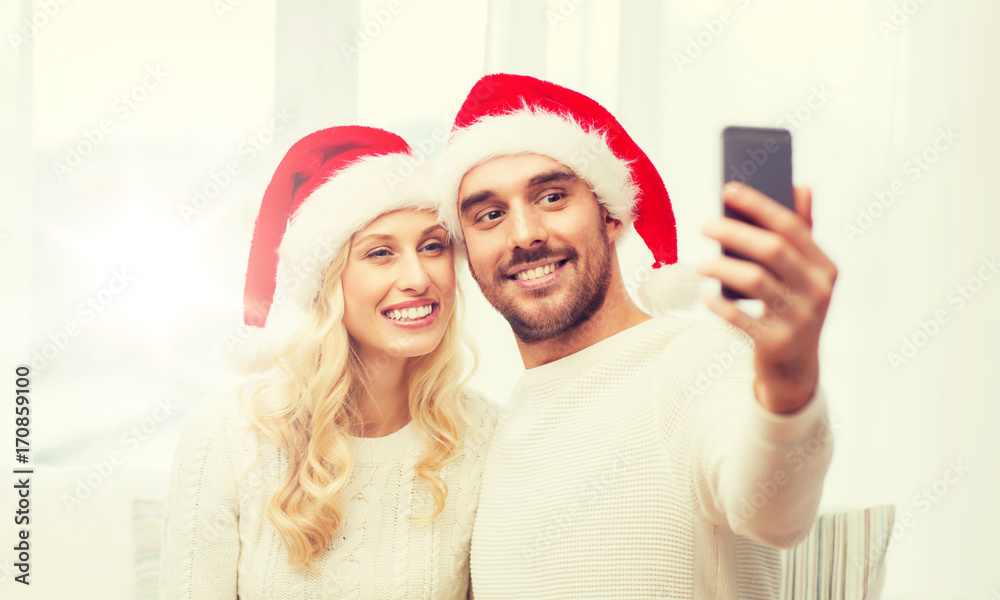 couple taking selfie with smartphone at christmas couple taking selfie with smartphone at christmas
