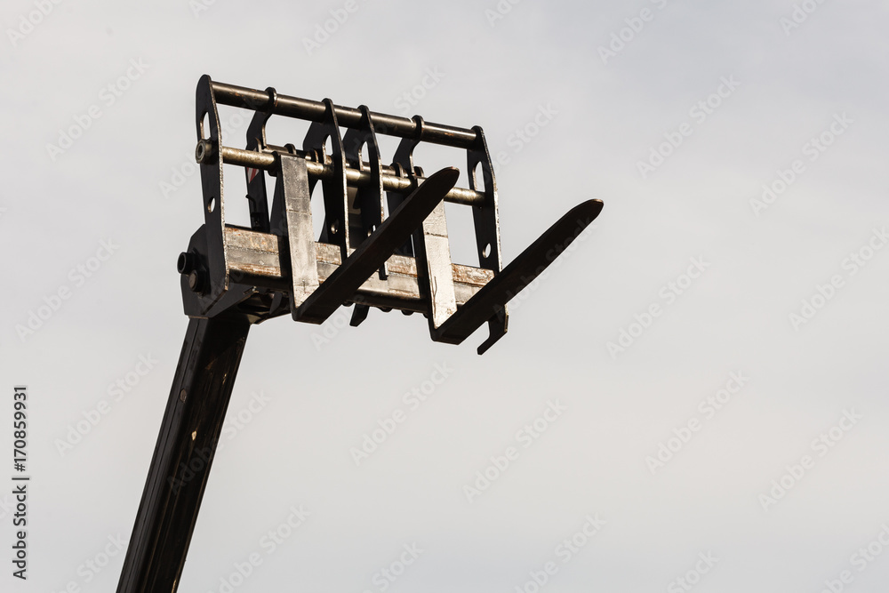 Bucket lift with blue sky in background Bucket lift with blue sky in background