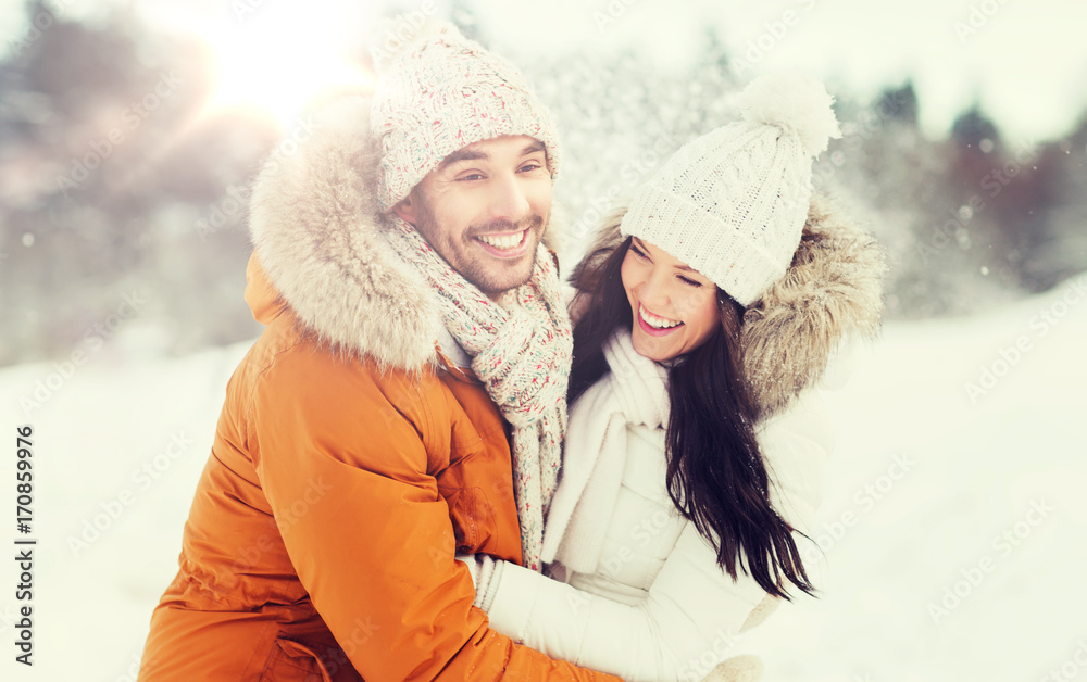 happy couple hugging and laughing in winter