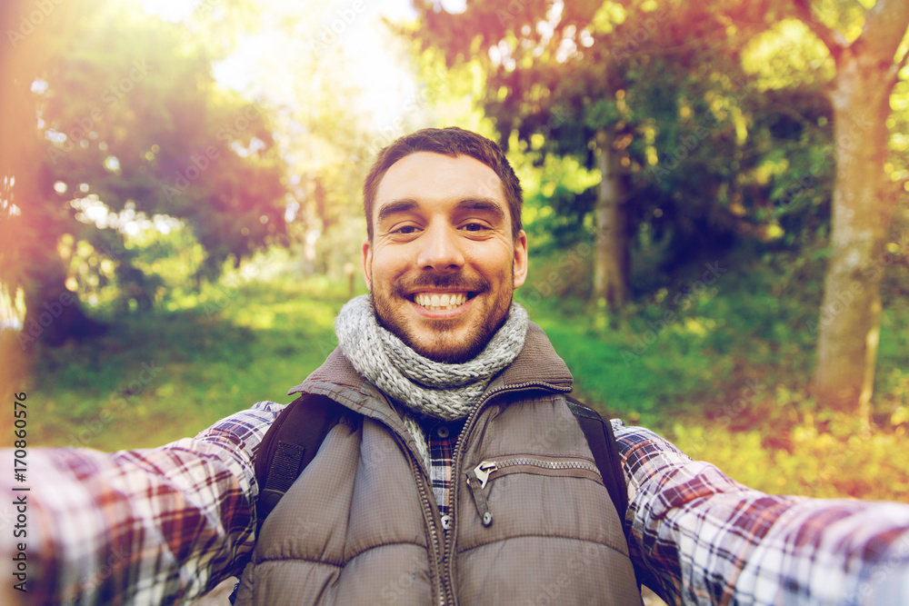 happy man with backpack taking selfie and hiking happy man with backpack taking selfie and hiking
