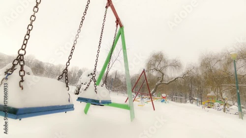 Children's playground covered with snow in winter
 photo