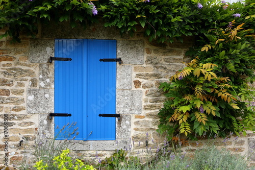Closed blue shutters in an ancient building in france
