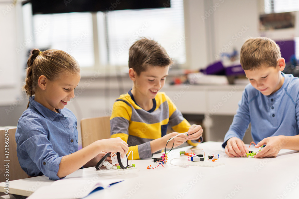 happy children building robots at robotics school happy children building robots at robotics school