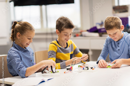 happy children building robots at robotics school