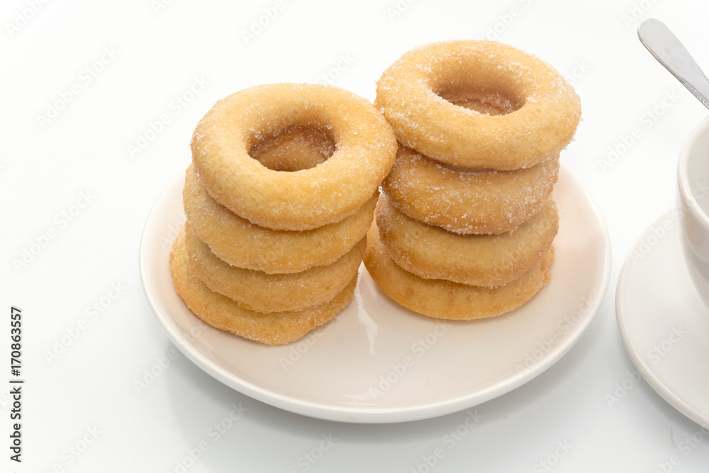 Fried Donuts with sugar topping and cup of coffee on white background