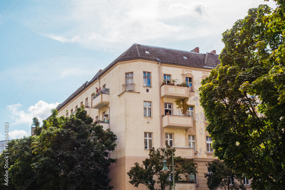 orange corner house with green trees