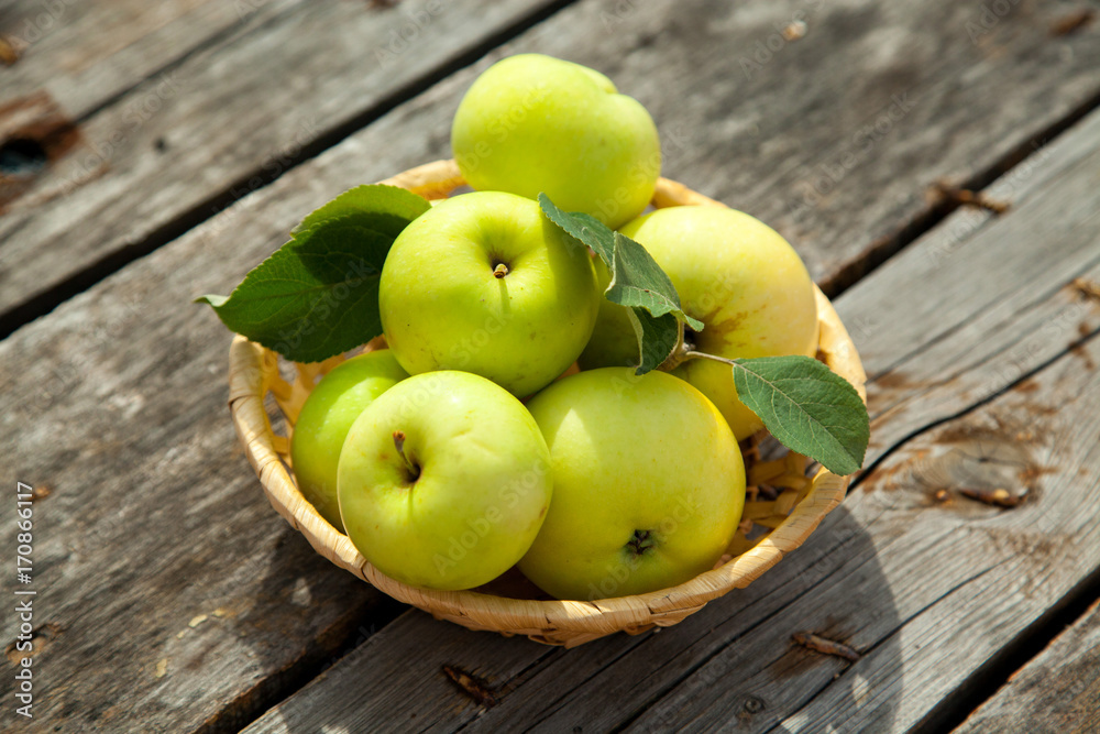 Green apples on a rustic wooden background Green apples on a rustic wooden background