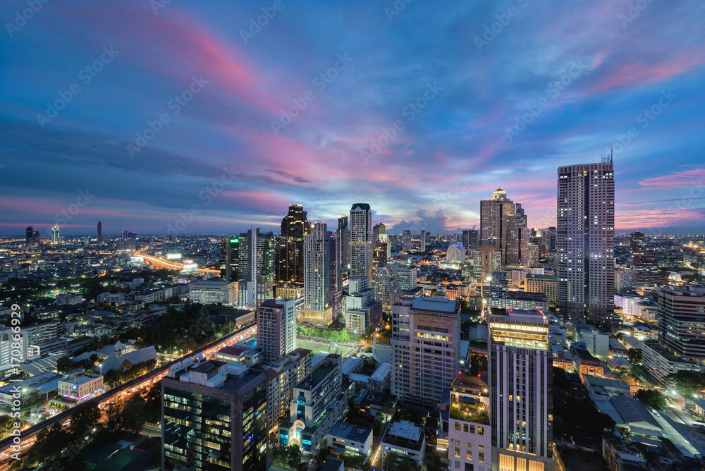 Bangkok skyline on colorful sunset sky and street lights