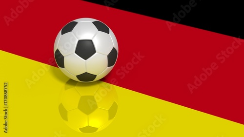 Black and white soccer ball on a reflecting german flag