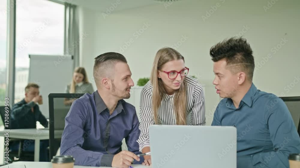 Creative business team meeting in modern start up office female team leader pointing at screen discussing diverse people group teamwork using laptop display Creative business team meeting in modern start up office female team leader pointing at screen discussing diverse people group teamwork using laptop display