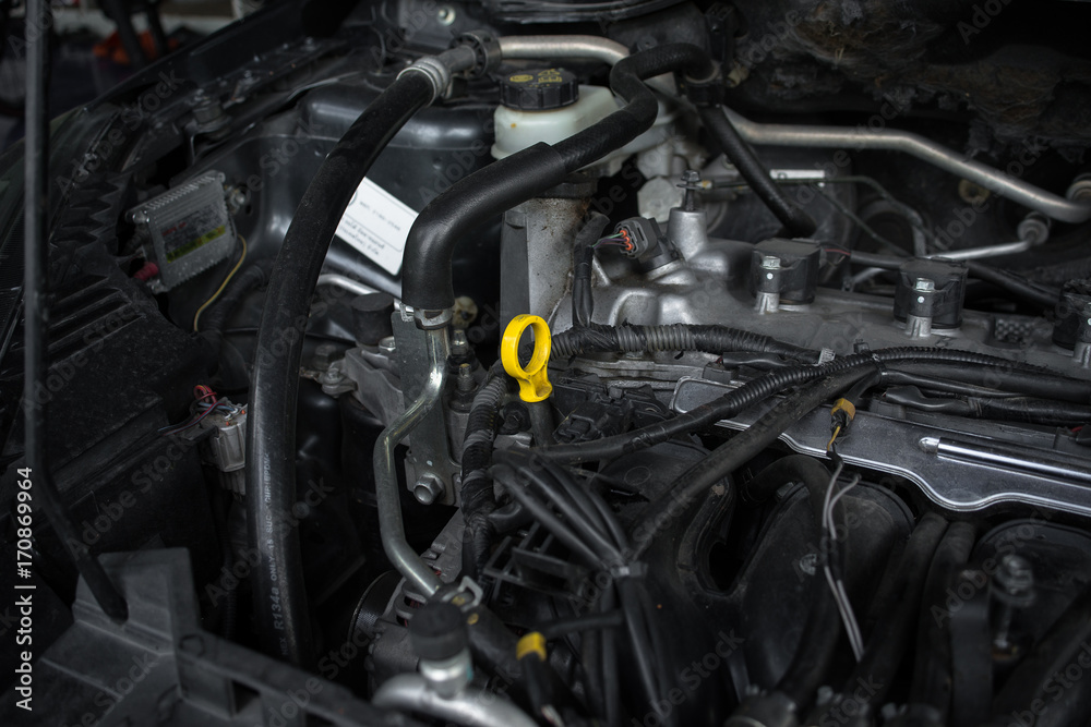 Oil dipstick in car engine room. Selective focus - Car maintenance