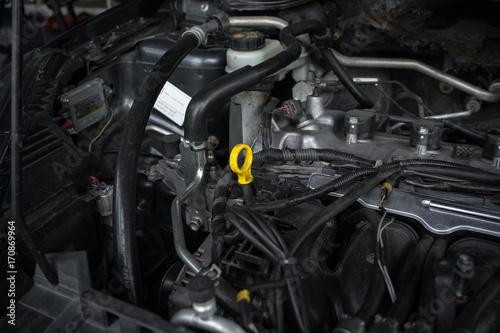 Oil dipstick in car engine room. Selective focus - Car maintenance
