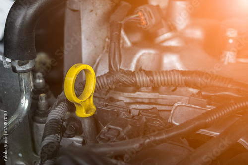 Oil dipstick in car engine room. Selective focus - Car maintenance
