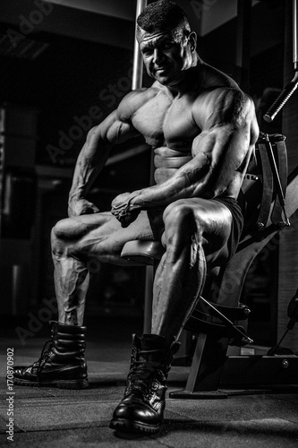 Brutal Caucasian bodybuilder working out in gym © antondotsenko