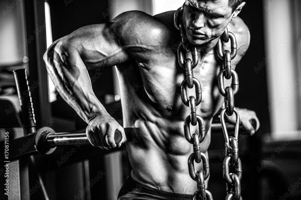 Brutal Caucasian bodybuilder training chest in gym