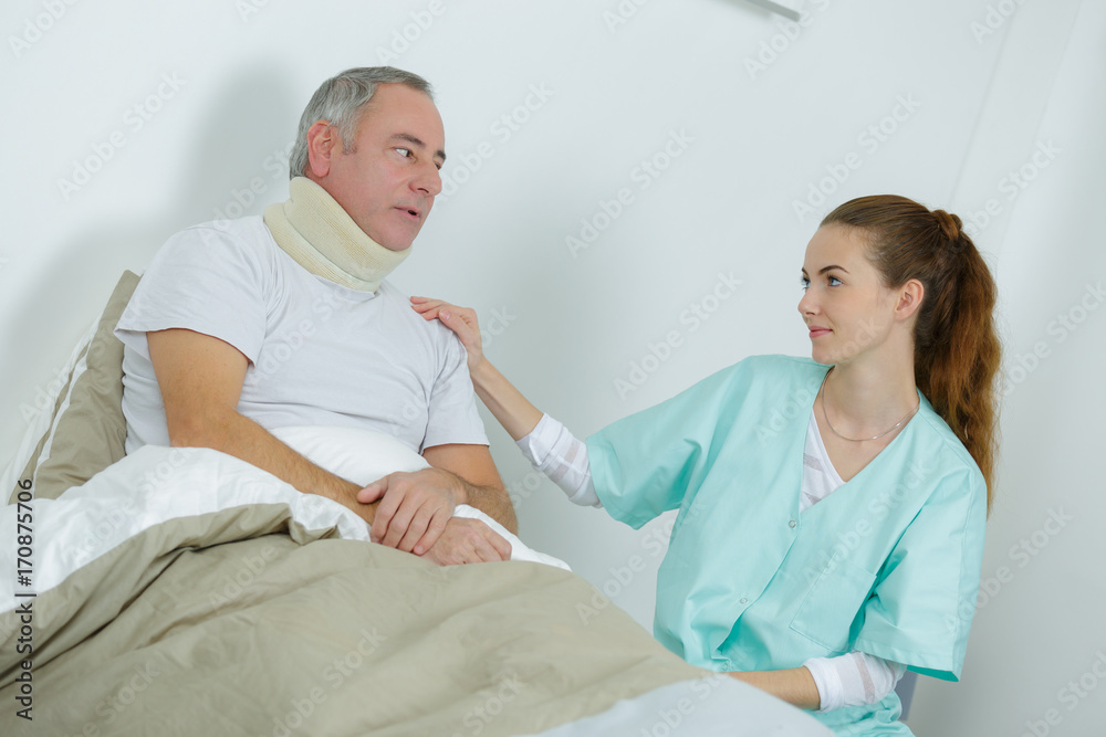 Obraz premium beautiful female nurse and an old man at the hospital