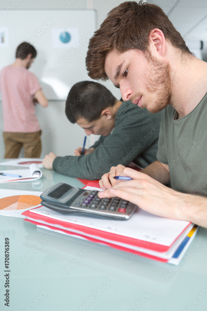 students with notebook and calculator at school students with notebook and calculator at school