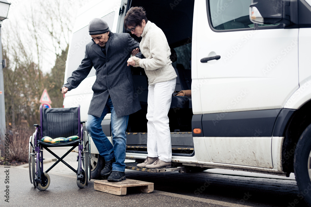 Nurse Helping Senior Man Exit A Van Nurse Helping Senior Man Exit A Van