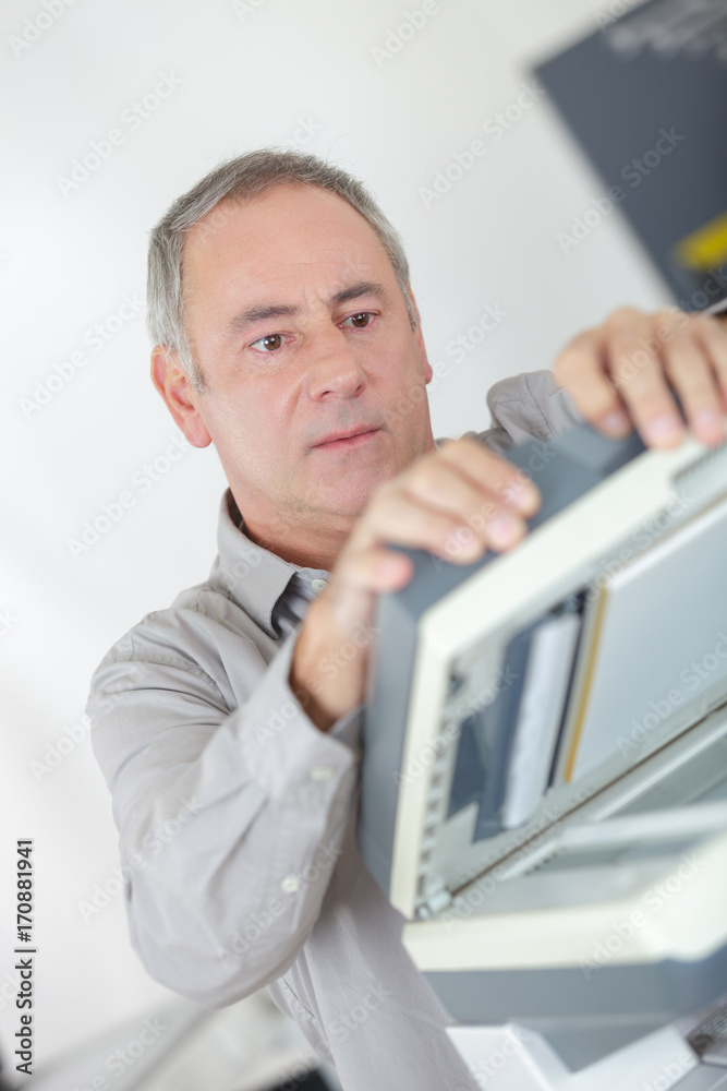 businessman hold ink cartridge to put into printer businessman hold ink cartridge to put into printer