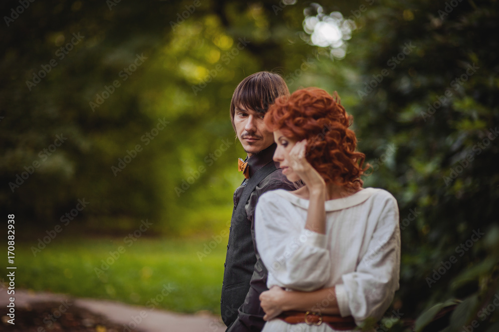Fototapeta premium groom and bride in white wedding dress enjoying in green forest