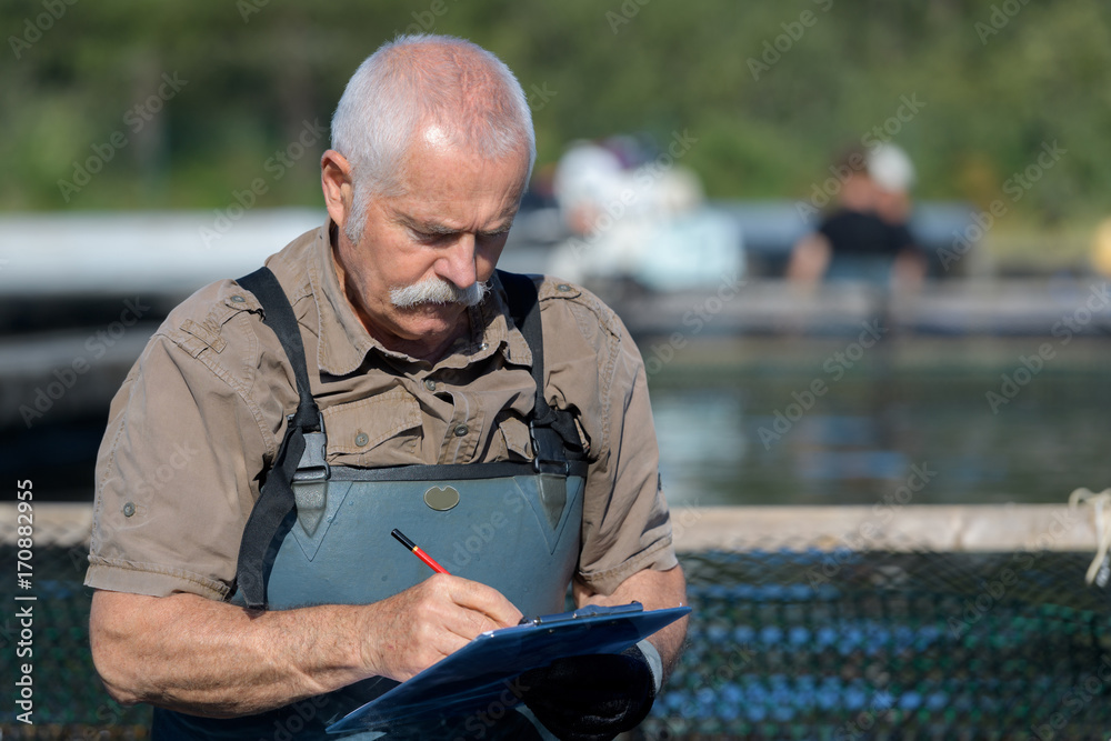 Fototapeta premium fish farmer writing notes