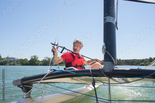 man sailing with sails out on a sunny day © auremar
