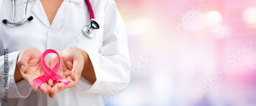 Doctor Hands Holding Pink Cancer Awareness Ribbon
