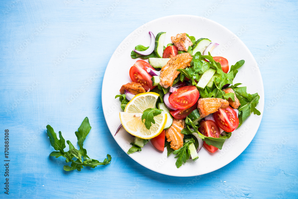Fresh salad with salmon and vegetables on blue. Fresh salad with salmon and vegetables on blue.