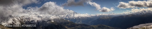 landscape, snow-capped peaks of the mountains of Svaneti in the clouds view of the valley, Svaneti, Georgia © uiliia