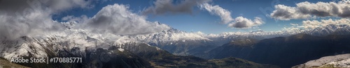 landscape, snow-capped peaks of the mountains of Svaneti in the clouds view of the valley, Svaneti, Georgia © uiliia