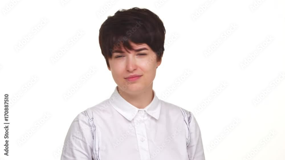 Concentrated woman in white skirt looking with negation at camera isolated over white background. Concept of emotions Concentrated woman in white skirt looking with negation at camera isolated over white background. Concept of emotions