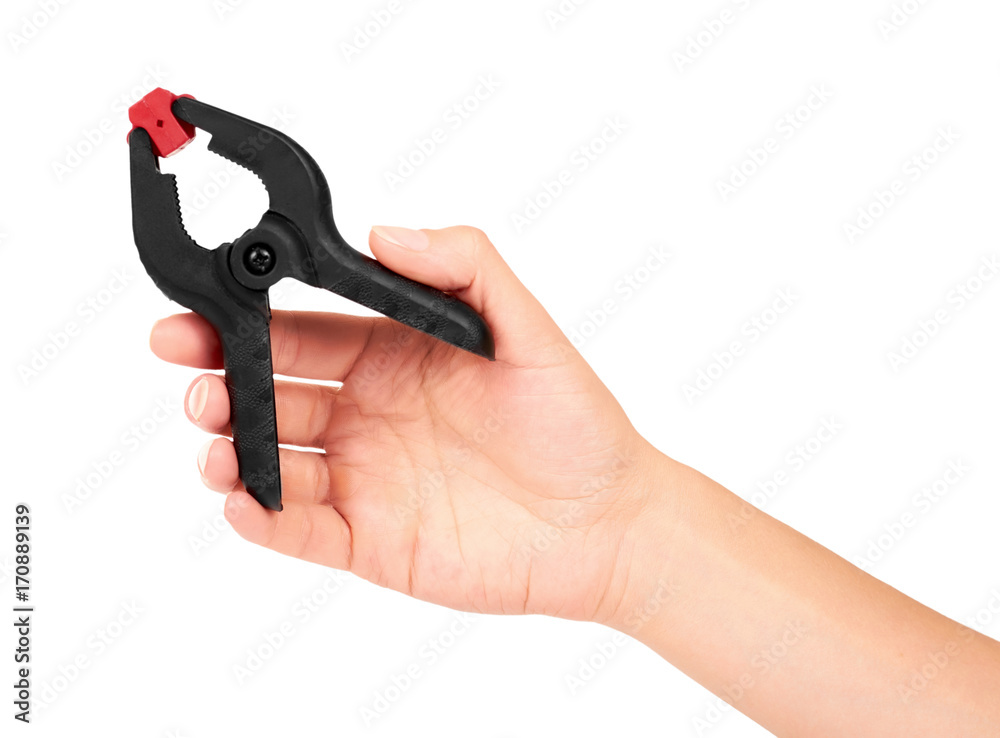 Black plastic clamp in hand isolated on white background Black plastic clamp in hand isolated on white background
