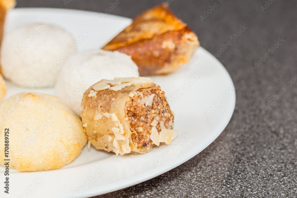 Delicious assortment of homemade Asian pastries. Samosas with a rose flower and banana balls