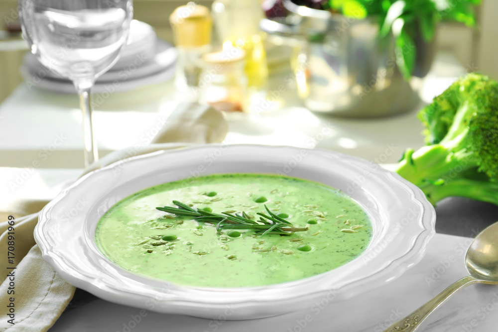 Plate with delicious creamy broccoli soup on table Plate with delicious creamy broccoli soup on table