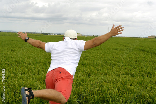Man and green rice field photo
