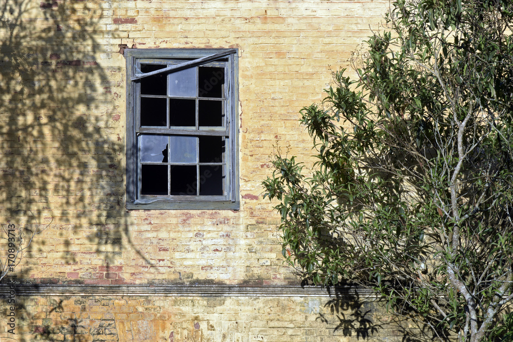 facade of old construction with broken window facade of old construction with broken window