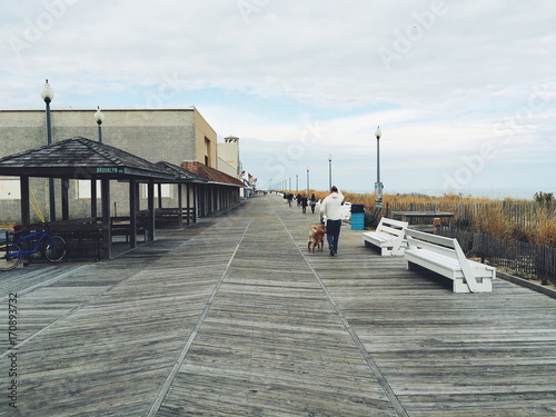 People walking on a beach boardwalk