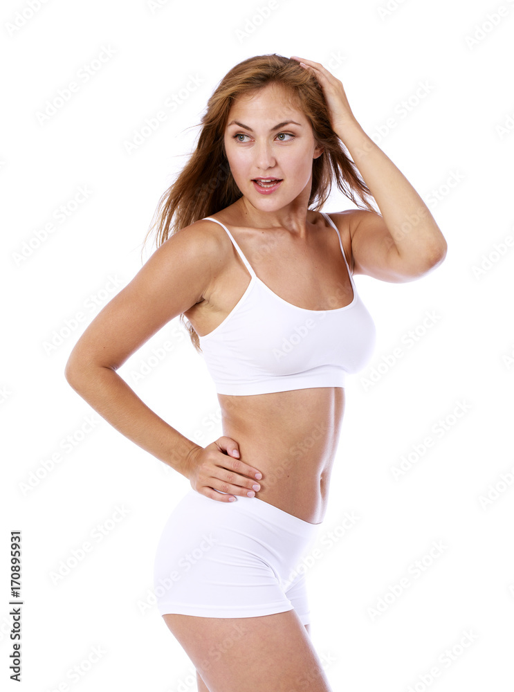 Young beautiful blonde woman in white fitness clothing Young beautiful blonde woman in white fitness clothing