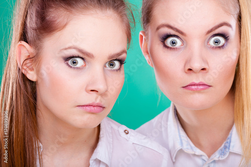 Two young women looking shocked