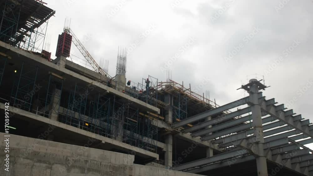Building construction. Builders are building an apartment house. Residential quarter in the process of construction. Building construction. Builders are building an apartment house. Residential quarter in the process of construction.
