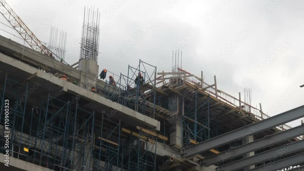 Building construction. Builders are building an apartment house. Residential quarter in the process of construction. Building construction. Builders are building an apartment house. Residential quarter in the process of construction.