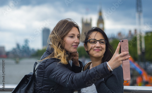 Girls make selfies during a city trip to London