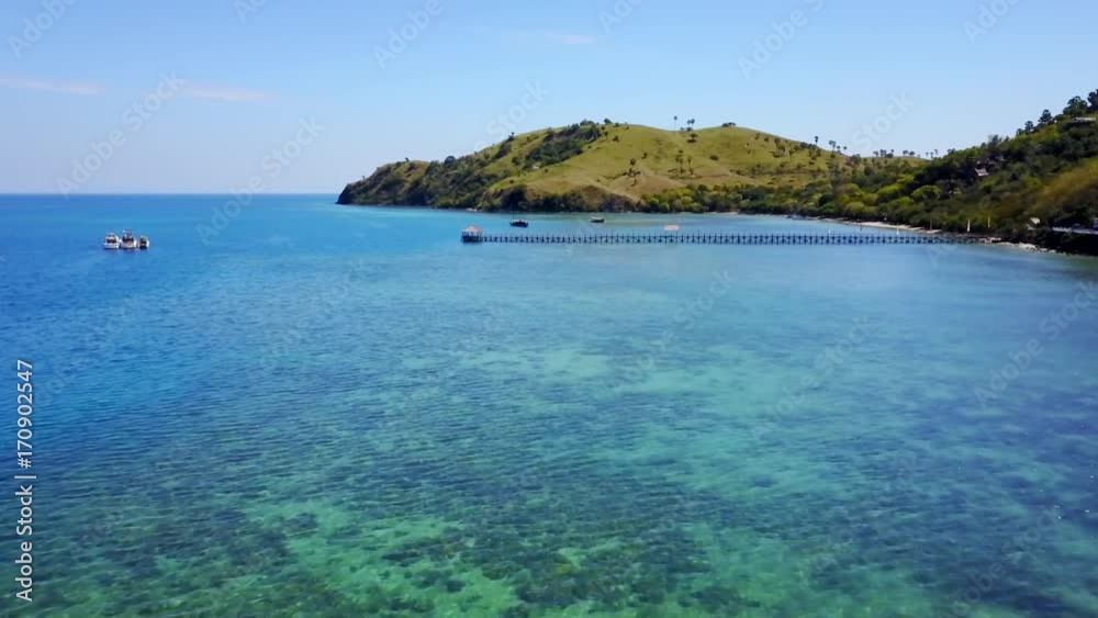 Scenic aerial landscape of turquoise sea water from a drone flying forward in Labuan Bajo, Flores Island an island located near Bali, Indonesia. Shot in 4k resolution Scenic aerial landscape of turquoise sea water from a drone flying forward in Labuan Bajo, Flores Island an island located near Bali, Indonesia. Shot in 4k resolution