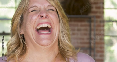 Woman laughing out loud lol cracking up and being hysterical