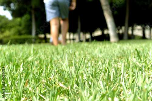 Walking on green juicy grass with barefeet