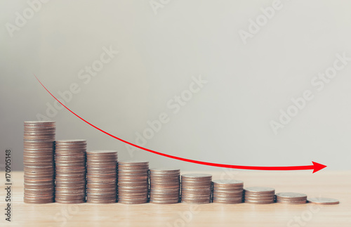 Coin stack step down graph with red arrow, Risk management business financial and investment, Copy space photo